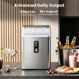 A stainless steel nugget ice maker machine filled with ice sits on a kitchen counter, surrounded by drinks, strawberries, blueberries, and a bottle bucket. Text at the top reads 'Enhanced Daily Output' with '35lbs/24h large ice output' and '50+ Cups of Chewable Nugget Ice Daily'.