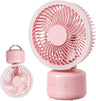 Pink portable desk fan shown from multiple angles on a clean white background, including a larger side view and a smaller front view with a carrying handle.